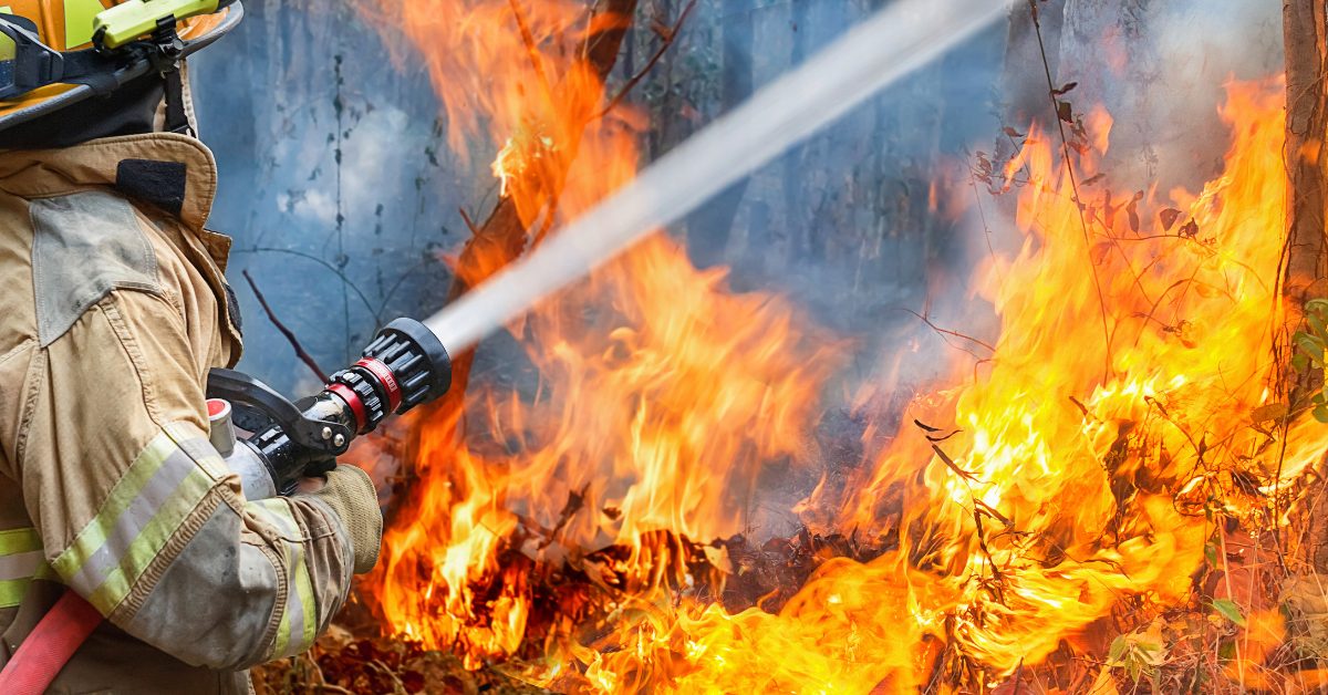 firefighter fighting fire with hose